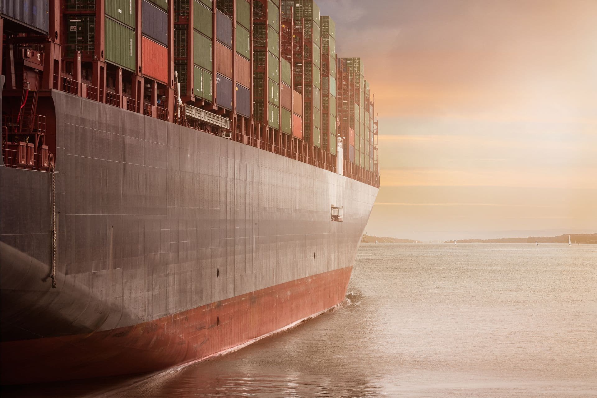 Loaded container ship at sunset