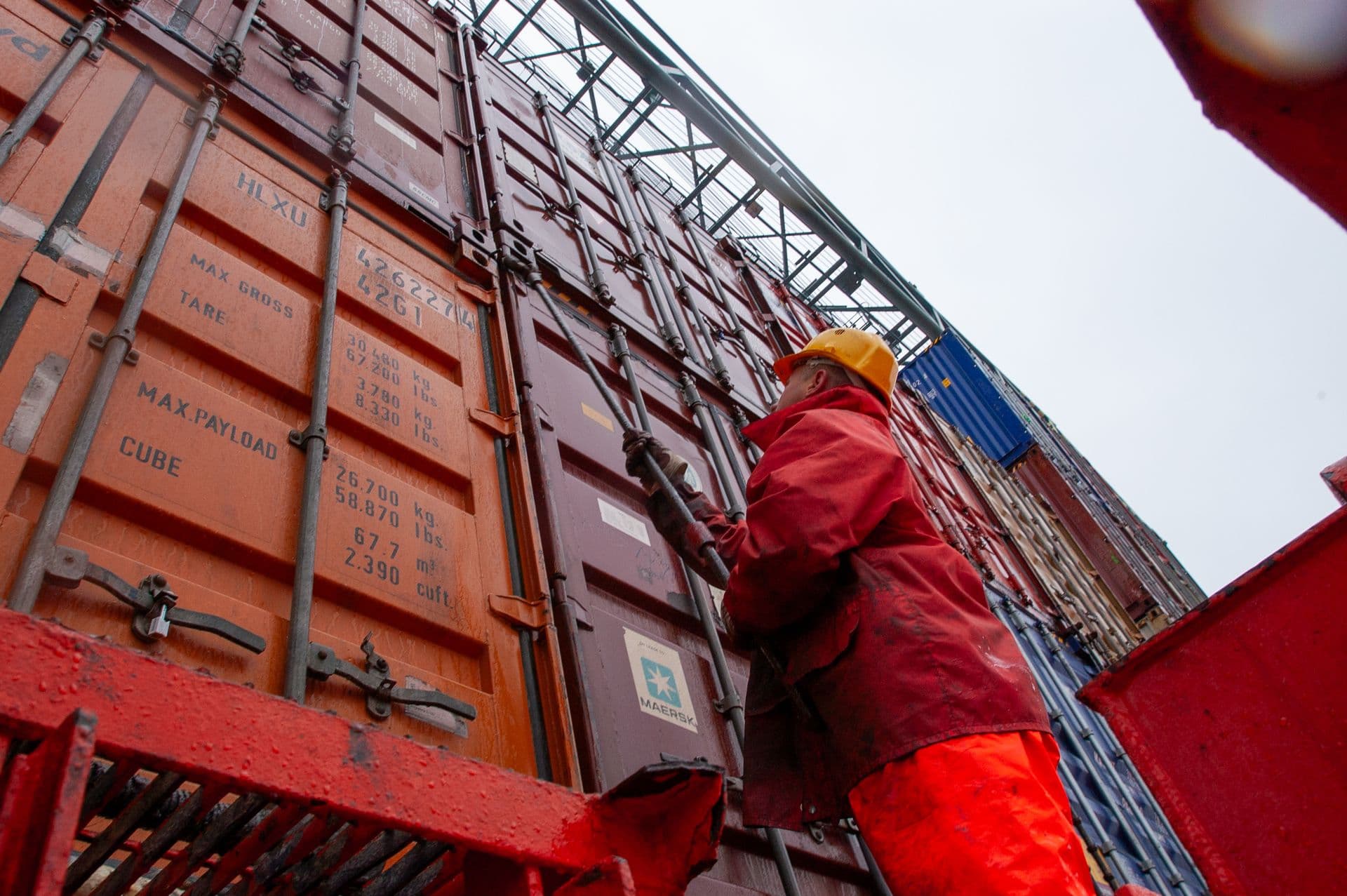 Port worker securing cargo containers