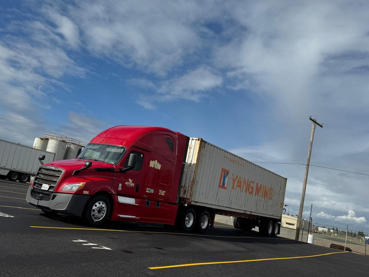 Avtar Freightways truck hauling a Yang Ming ocean container
