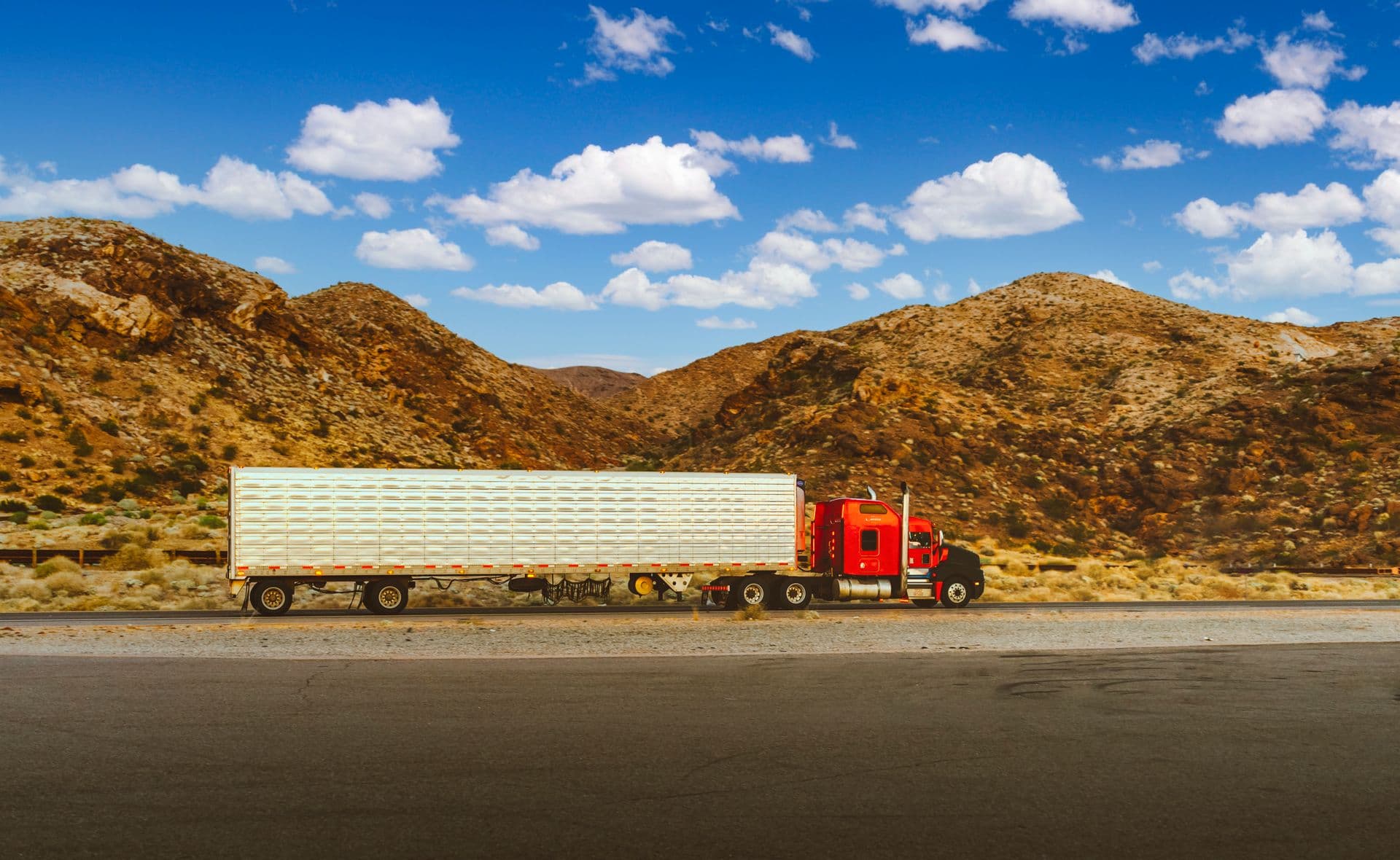 Red American semi truck crossing the Nevada desert